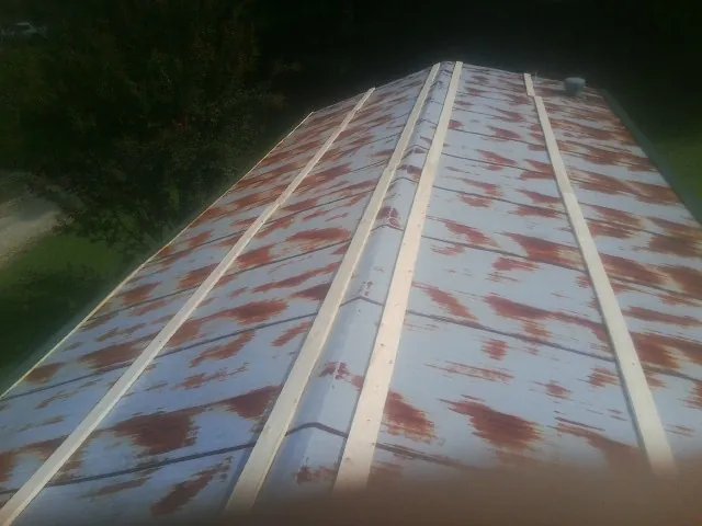Rusted metal roof panels with new wood purlins before replacement — Storm Damage Roof Repair in Pequannock by Roofing Brothers