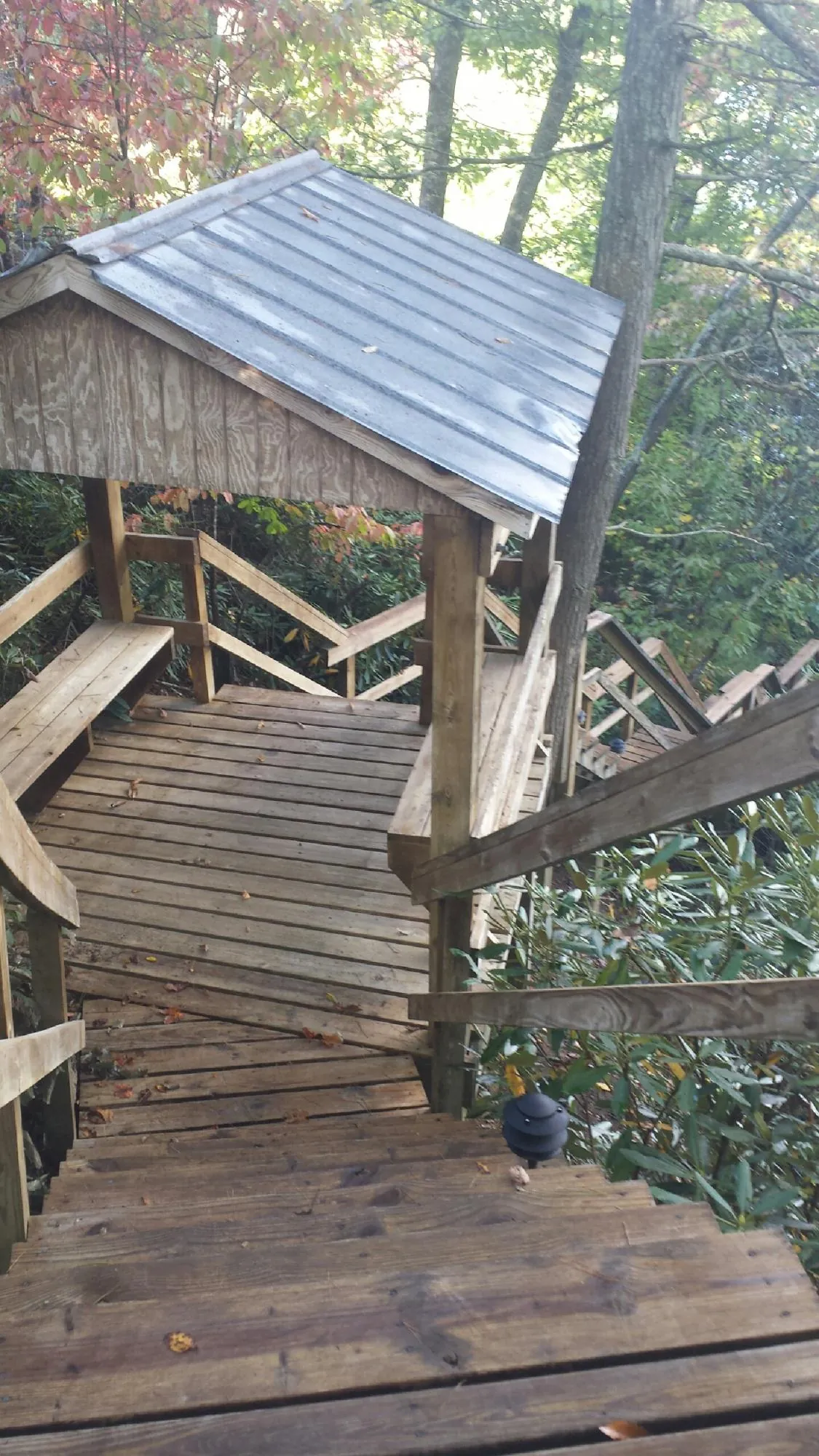 Metal roofed shelter over wooden steps on a wooded walkway — Skylight Repair & Installation work by our crew in Pequannock