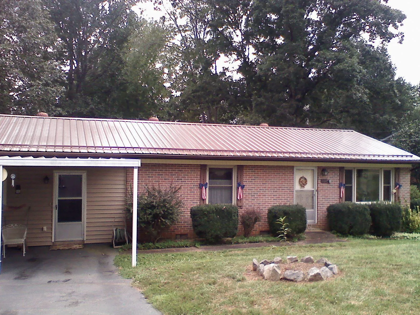 Bronze metal roof and carport on a brick ranch home — Roof Repair work by our crew in Pequannock